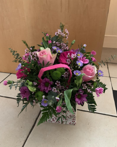 A Little Something - Show your affection with this mouth-watering mix of classical flowers delivered in a delightful gift bag or box.